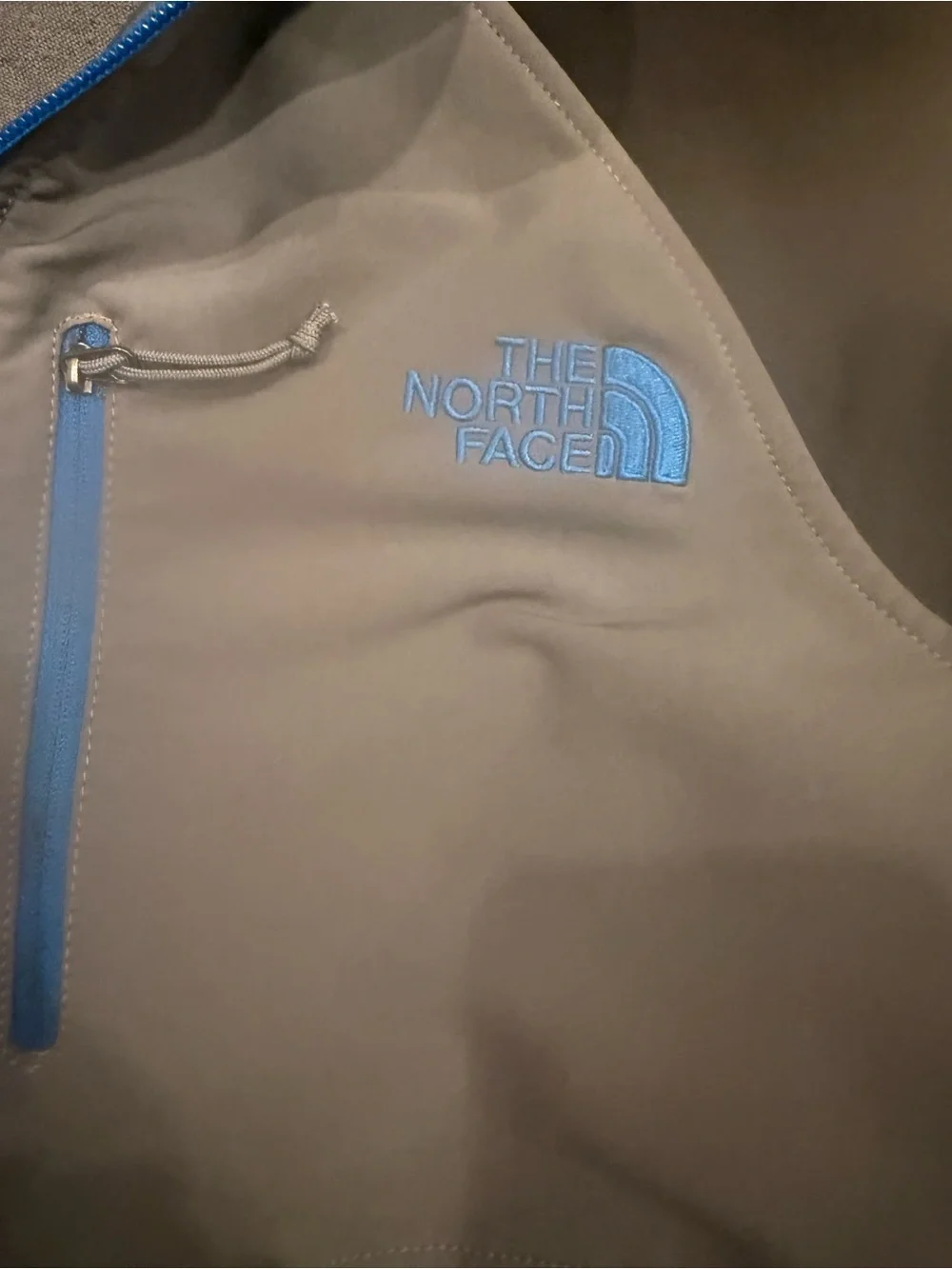 The North Face Men’s Gray Softshell Jacket with Black Sleeves and Blue Trim